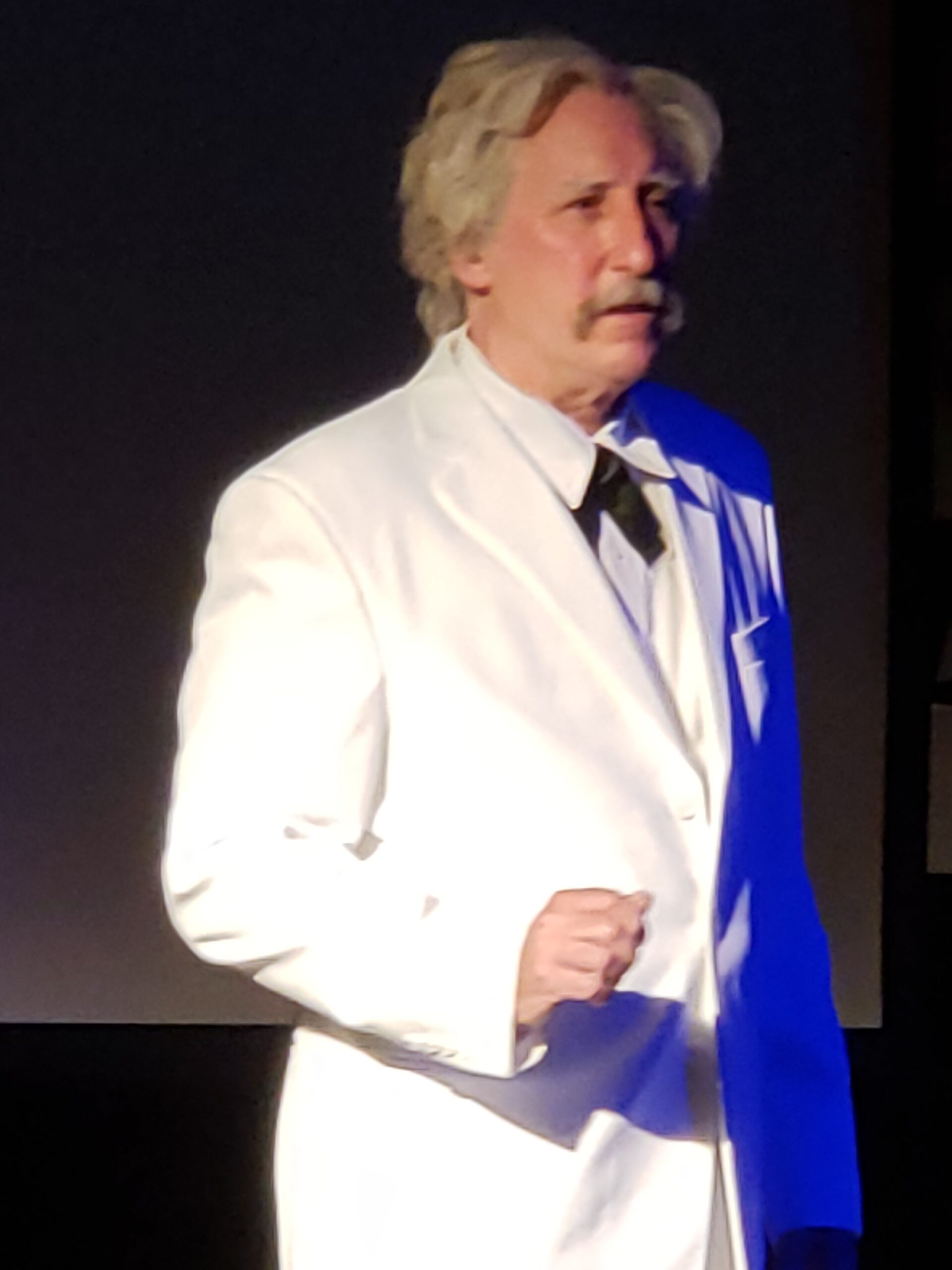 Joe Baer portrays Mark Twain, standing